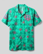 Front view of the let's go girls flamingo camp shirt featuring vibrant turquoise with floral peace sign designs.