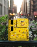 Front view of the playful duck leather tumbler storage bag, featuring a vibrant yellow design with floral accents.