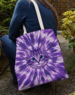 Purple aura cat tote bag with vibrant tie-dye design, showcasing a cute cat face from a side angle.