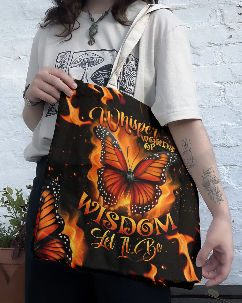 Whisper Words of Wisdom Butterfly Tote Bag Detail shot showcasing the bold text and butterfly design on the whisper words of wisdom butterfly tote bag.