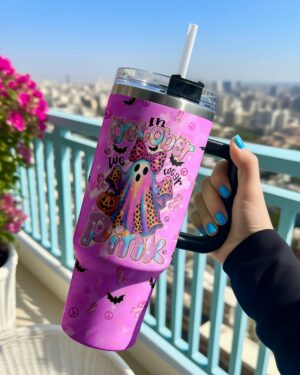 Front view of the IN OCTOBER WE WEAR PINK BOO tumbler showcasing its vibrant pink design and playful ghost graphics.