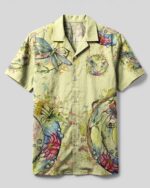 Front view of the spirit of a fairy dragonfly camp shirt showcasing vibrant floral designs on a light green background.
