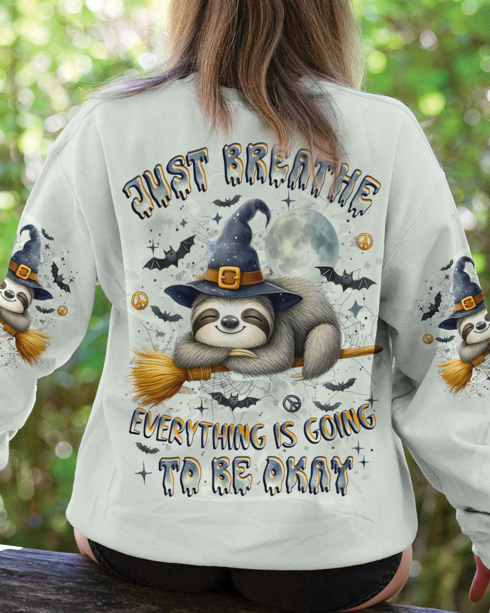 Just Breathe Sloth Witch Halloween Shirt Close-up of the sloth in the just breathe sloth witch shirt, focusing on the cute expression and Halloween hat.