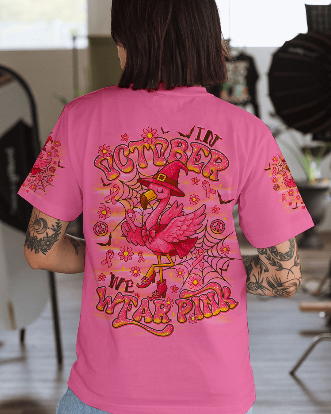 Pink Flamingo Witch Shirt | All Over Print Clothes Lifestyle image of a woman wearing the pink flamingo witch shirt, enjoying a fall day outdoors.