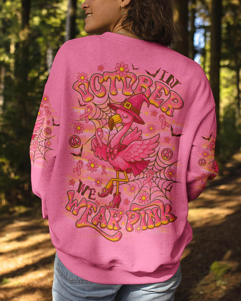 Pink Flamingo Witch Shirt | All Over Print Clothes Overhead shot of the pink flamingo witch shirt laid flat, highlighting its vivid pink color and design.