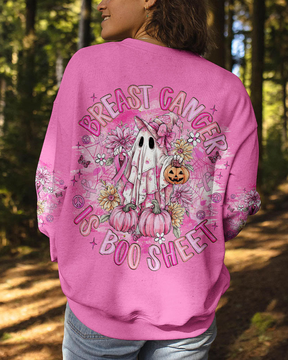 Breast Cancer Is Boo Sheet Shirt | All Over Print Full body image of a person in the breast cancer is boo sheet shirt, set against a backdrop of autumn leaves.