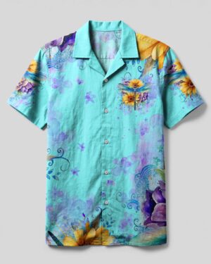 Front view of the just breathe dragonfly camp shirt in light blue with vibrant floral patterns.