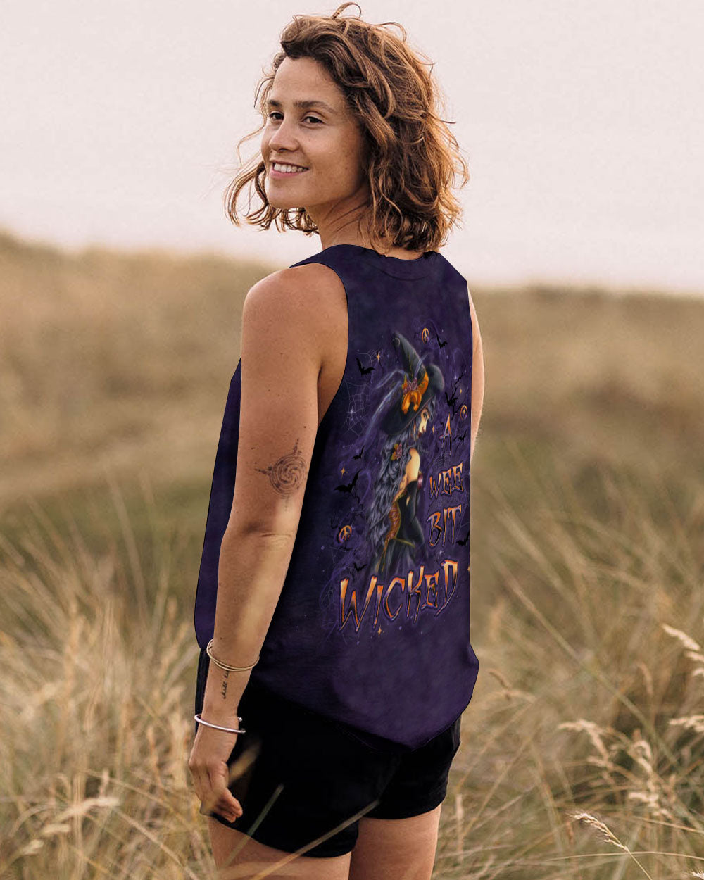A Wee Bit Wicked Witch Shirt | All Over Print Back design of the a wee bit wicked witch shirt, focusing on the captivating witch and Halloween imagery.