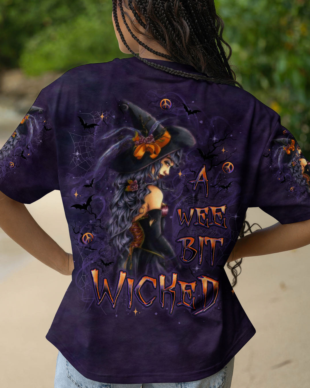 A Wee Bit Wicked Witch Shirt | All Over Print Close-up of the fabric texture on the a wee bit wicked witch shirt, highlighting vibrant colors and print quality.