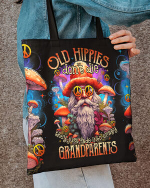 Colorful OLD HIPPIES DON'T DIE tote bag featuring a whimsical design of mushrooms and peace symbols from the front view.