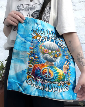 Front view of the old hippie don't die tote bag featuring vibrant tie-dye colors and floral design.