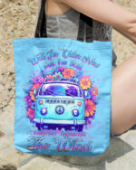 Front view of the RUNNING AGAINST THE WIND tote bag in blue with a colorful VW van and floral design.