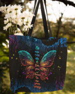 Front view of the choose to use your wings tote bag featuring a colorful butterfly design on a black background.