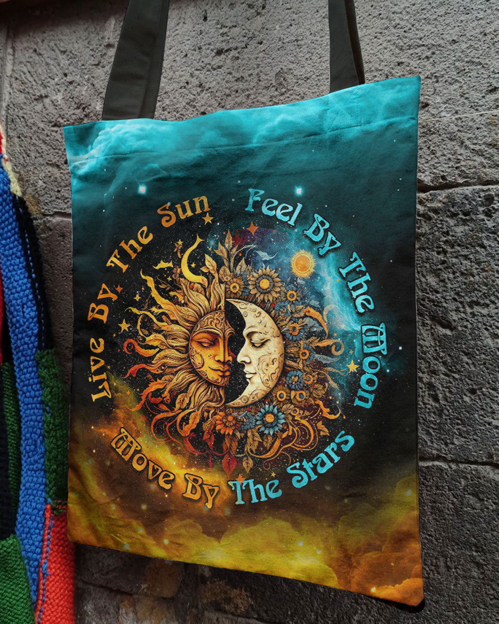 Live By The Sun Moon Stars Tote Bag Front view of the live by the sun moon stars tote bag featuring vibrant colors and celestial design.