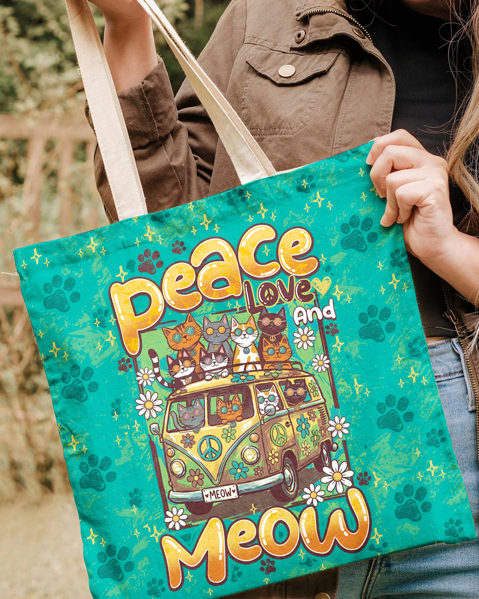 Peace Love And Meow Cats Tote Bag Close-up of the PEACE LOVE AND MEOW CATS TOTE BAG's printed design, highlighting playful cats and floral patterns on a colorf