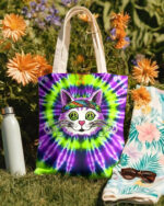 Front view of the purple green swirl cat tote bag featuring a vibrant tie-dye design and playful cat graphic.