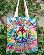 Front view of the imagine all the people tie dye tote bag showcasing vibrant colors and peace sign design.