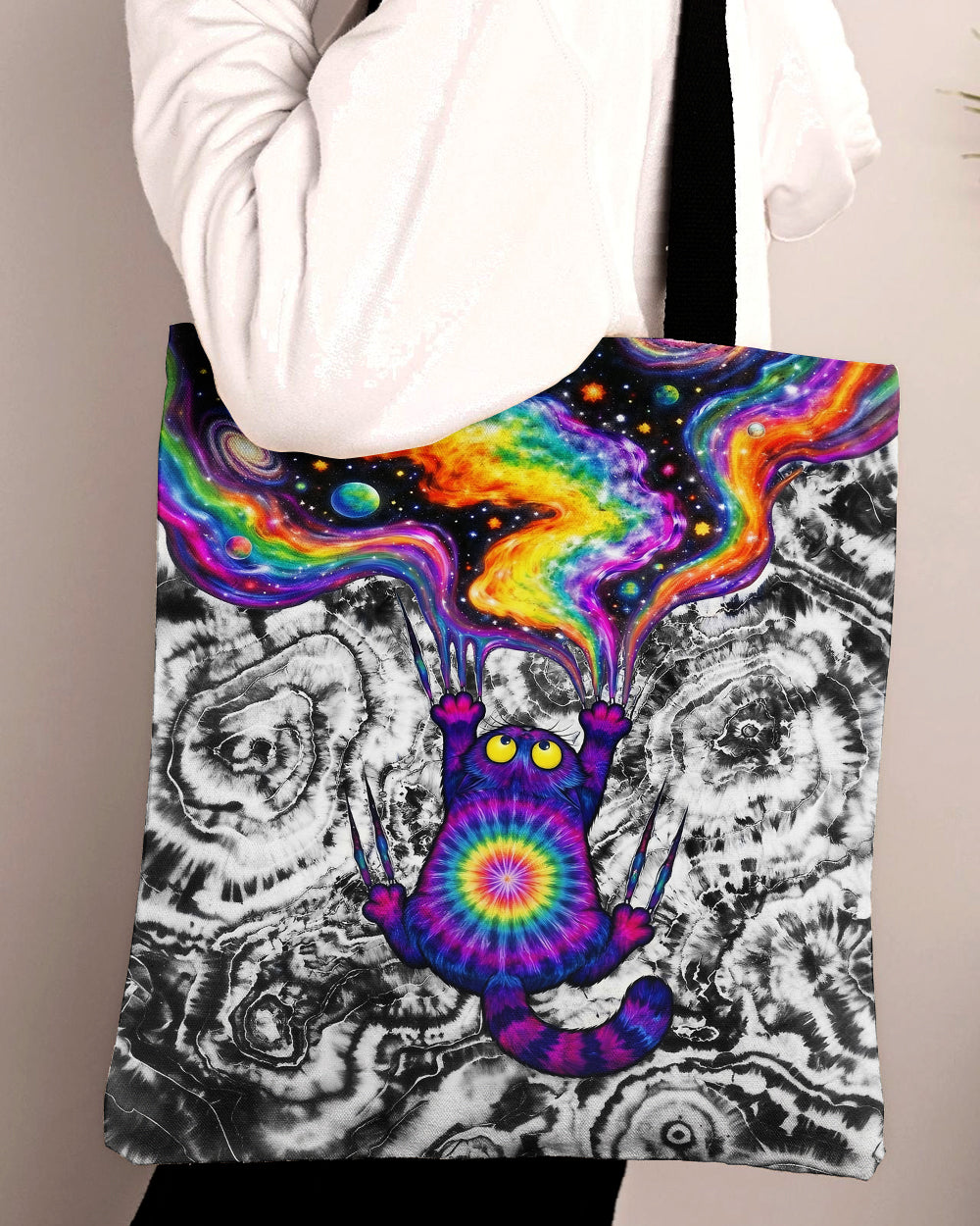 Scratching Cat Galaxy Tote Bag Colorful scratching cat galaxy tote bag held from the side, showcasing vibrant cat design and cosmic background.