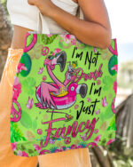 Front view of I'm Just Fancy Flamingo Tote Bag featuring vibrant green color and playful flamingo design.