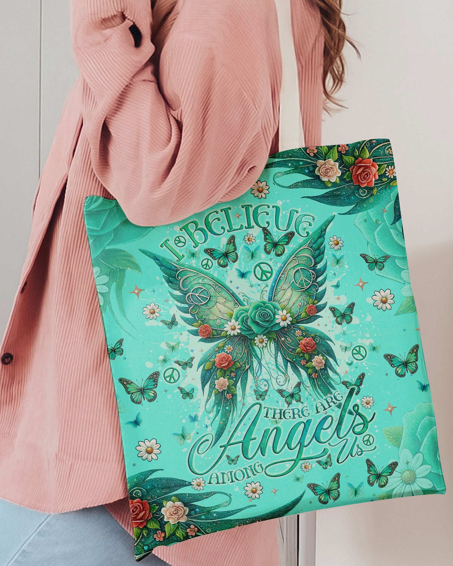 Angels Among Us Wings Tote Bag Lifestyle image showcasing the I Believe There Are Angels Among Us Wings Tote Bag, held by a woman in casual attire.