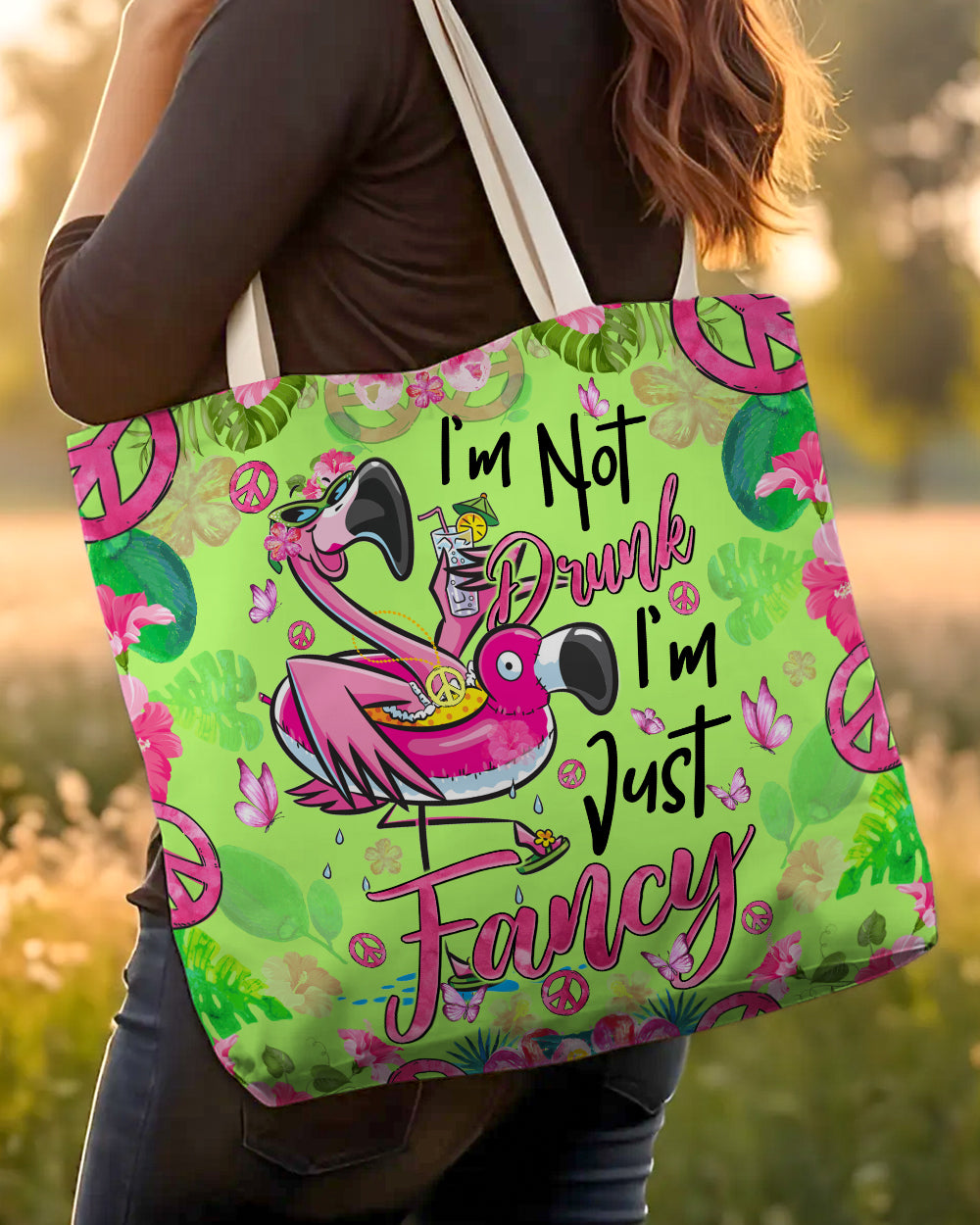 I'm Just Fancy Flamingo Tote Bag Close-up of I'm Just Fancy Flamingo Tote Bag highlighting the intricate floral and peace sign elements in the design.