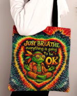 Front view of the just breathe frog swirl tote bag featuring vibrant tie-dye colors and a peaceful frog design.