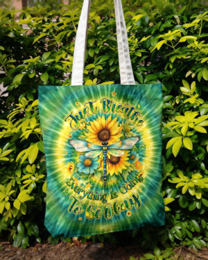 Front view of the Just Breathe Dragonfly Floral Swirl Tote Bag featuring vibrant sunflowers and a colorful swirl design.