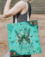 Front view of the I Believe There Are Angels Among Us Wings Tote Bag, featuring vibrant turquoise colors and floral designs.