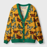 Front view of the Symphony of Wings cardigan sweater with vibrant butterfly prints on a yellow background.