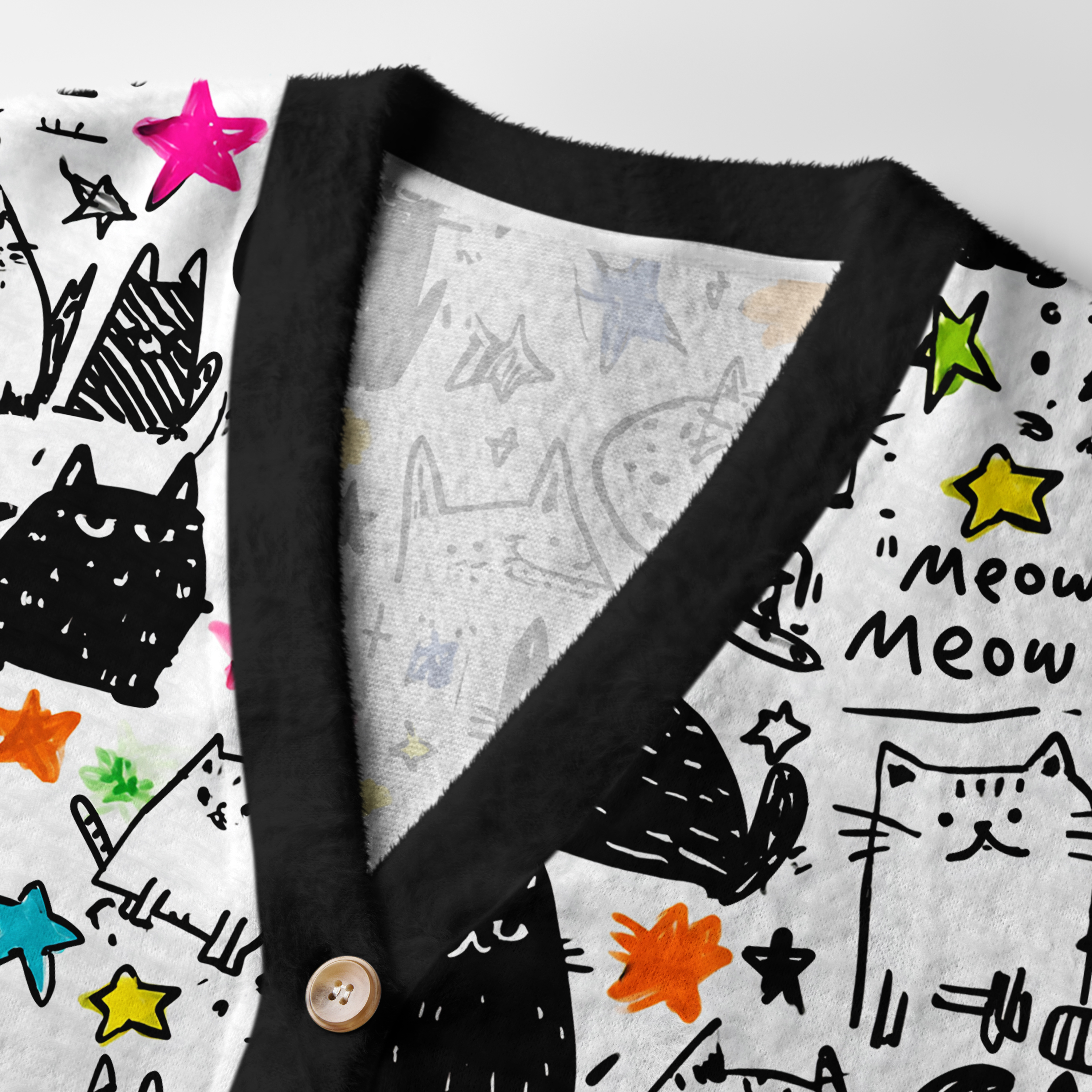 Cosmic Cat Doodles Cardigan Sweater | Celestial Cat Design Close-up detail of the cosmic cat doodles cardigan sweater highlighting the unique button design and soft fabric texture.
