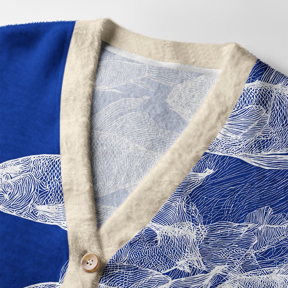 Blueprint of the Sea Cardigan Sweater Detail shot of the blueprint of the sea cardigan sweater highlighting the textured fabric and unique fish patterns.
