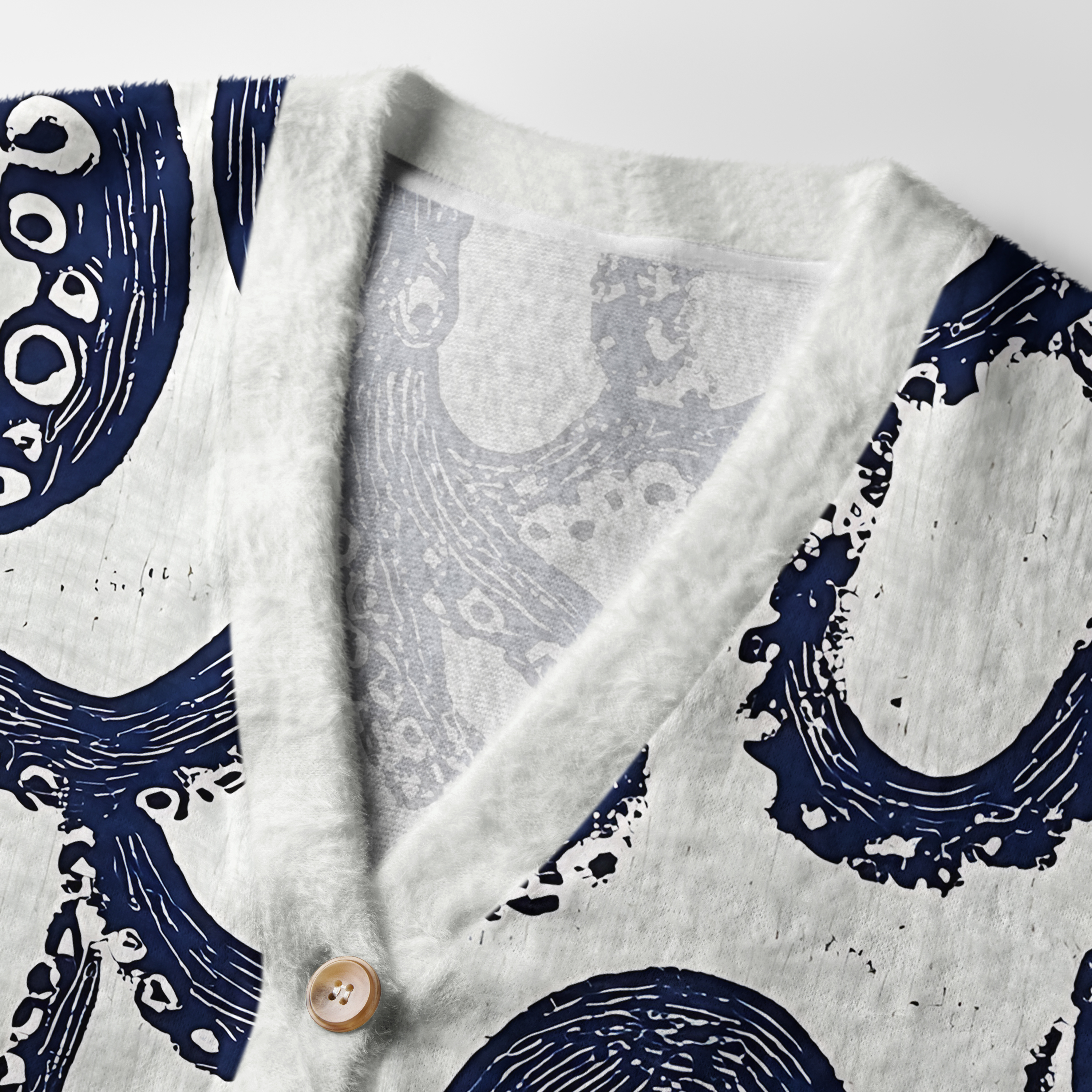 Ocean Octopus Cardigan Sweater | Sea Life Design Close-up detail of the ocean octopus cardigan sweater's textured fabric and wooden buttons highlighting its unique design.