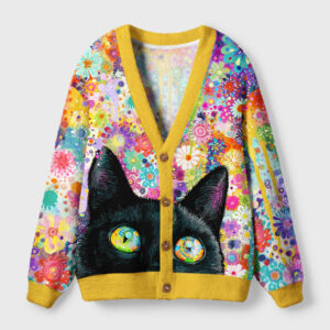 Front view of the cat among flowers cardigan sweater featuring a vibrant floral design and a black cat's face.