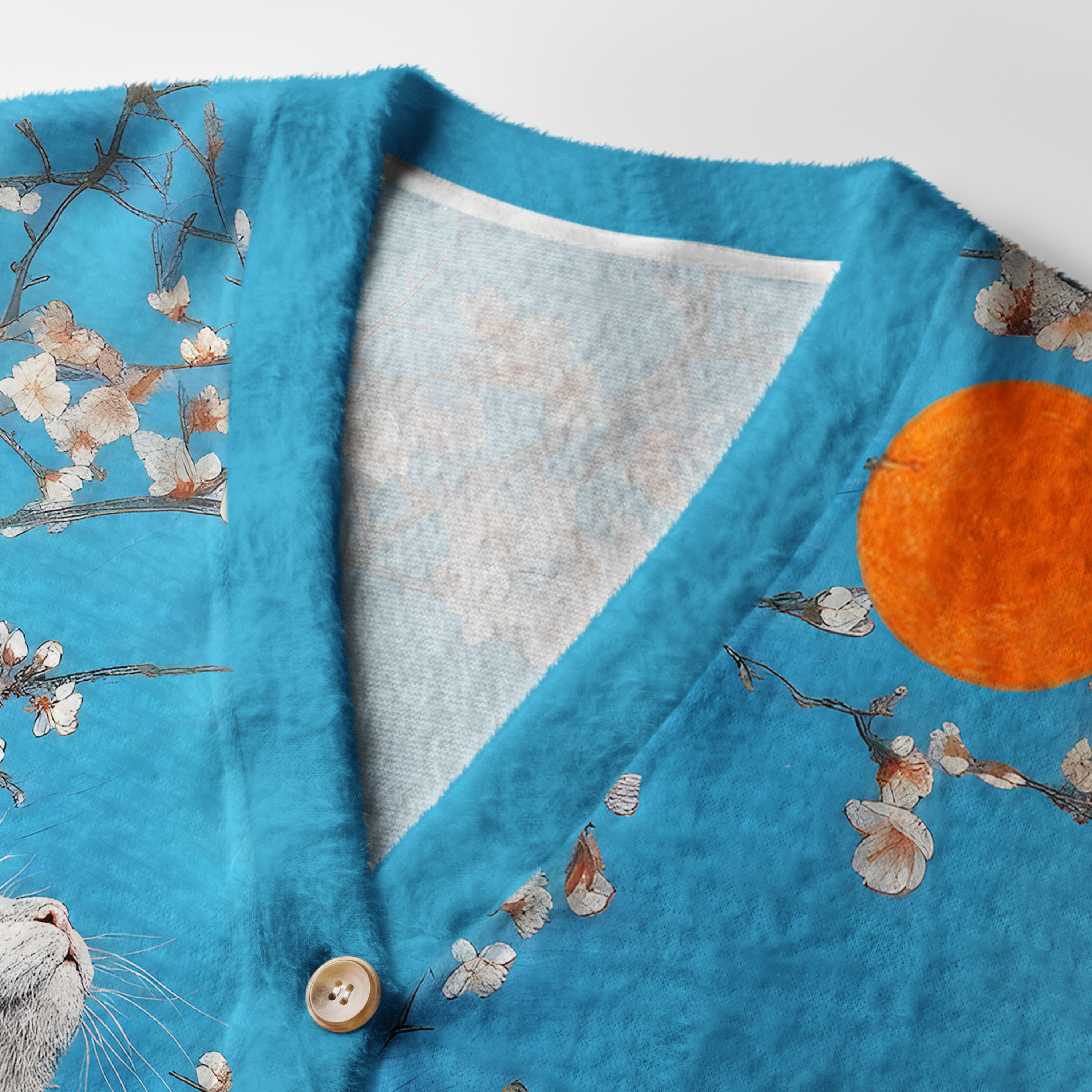 Cat Looking at the Sun Cardigan Sweater Close-up detail of the cat looking at the sun cardigan sweater, highlighting the intricate cat illustration and buttons.