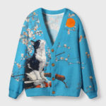 Front view of the cat looking at the sun cardigan sweater in blue, featuring a cat design and floral accents.