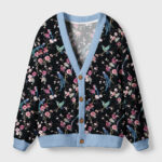 Front view of the Birds & Blooms cardigan sweater featuring a black floral bird design and soft blue trim.