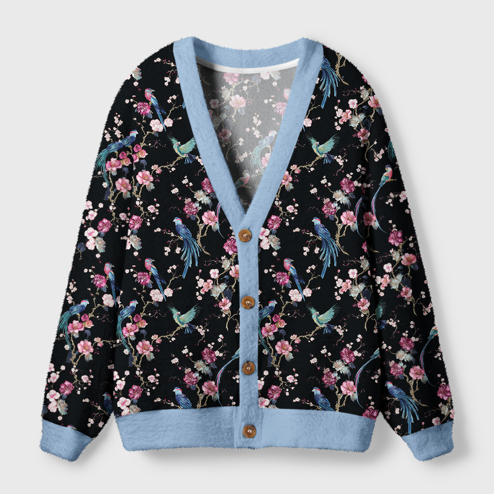 Birds and Blooms Cardigan Sweater Front view of the Birds & Blooms cardigan sweater featuring a black floral bird design and soft blue trim.