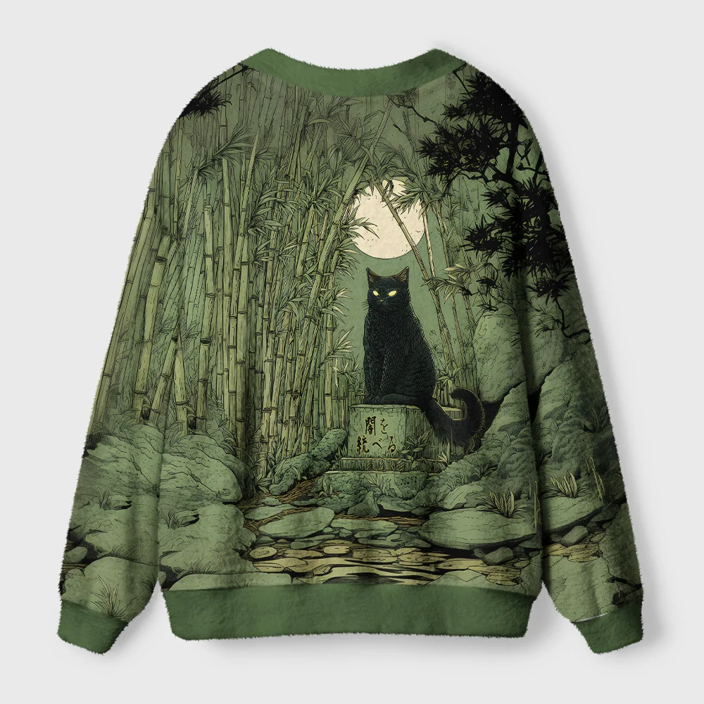 Cat Under the Moon Cardigan Sweater Back view of the cat under the moon cardigan sweater showcasing its detailed celestial pattern against a green backdrop.