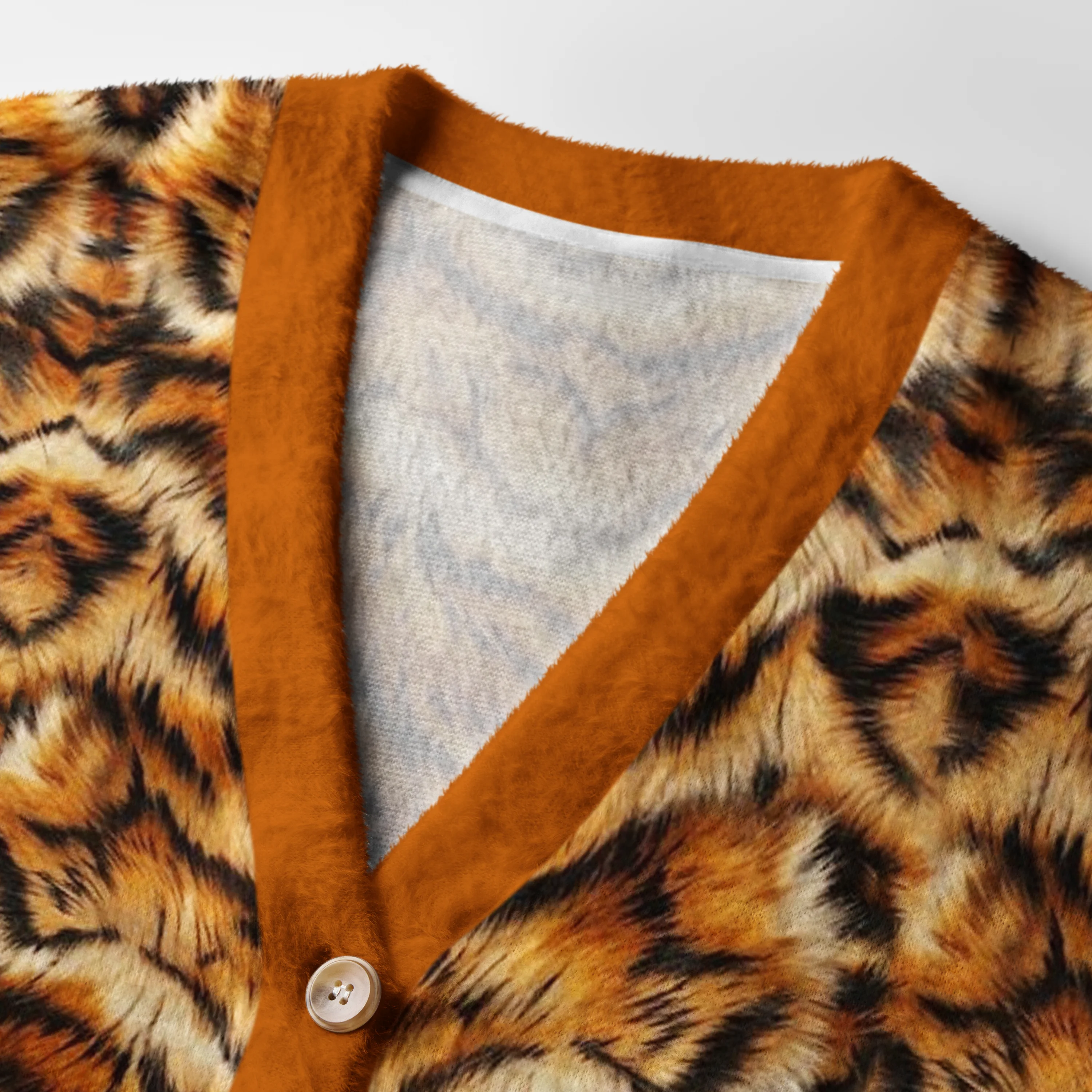 Bold Tiger Stripes Cardigan Sweater Close-up detail of the tiger stripes cardigan sweater's buttons and texture, emphasizing its cozy feel and wild design.