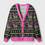 Frogs in the void cardigan sweater features a vibrant pink trim and surreal frog design from the front view.
